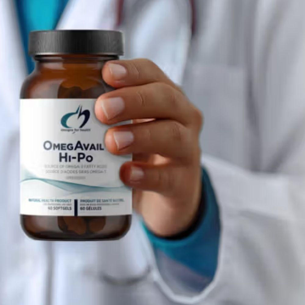 Hand holding a bottle of OmegaAvail Hi-Po supplement with a blurred background