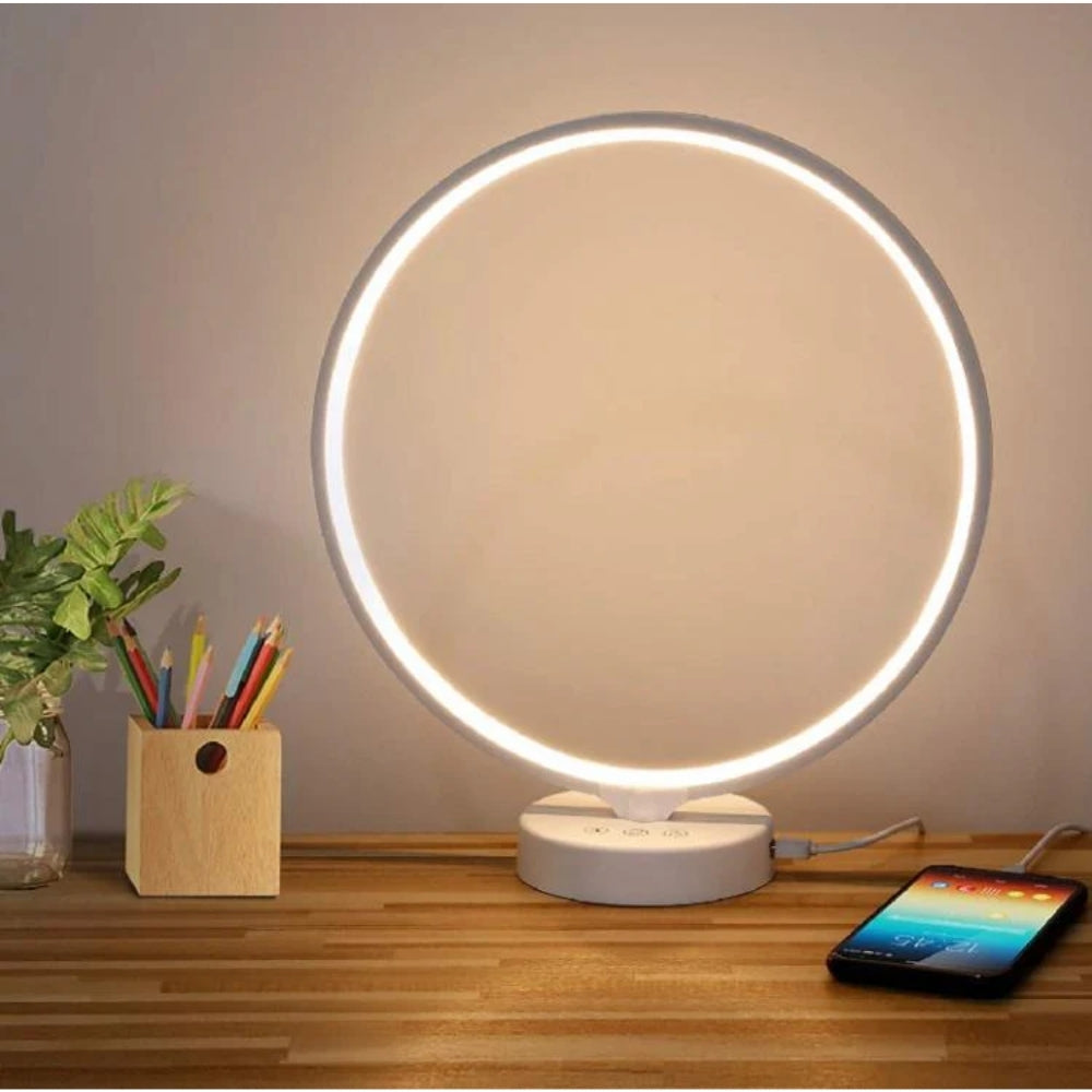 Kala SAD Therapy Lamp on a wooden surface with a phone and pencil holder