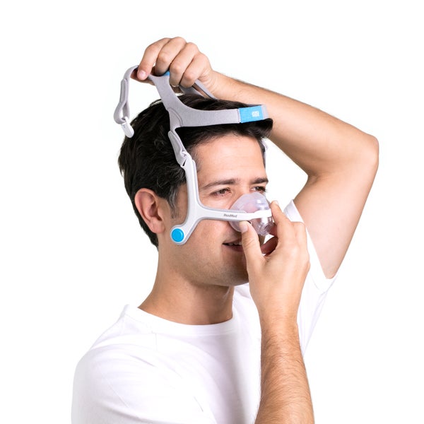 Person putting on the ResMed AirFit N20 nasal CPAP mask