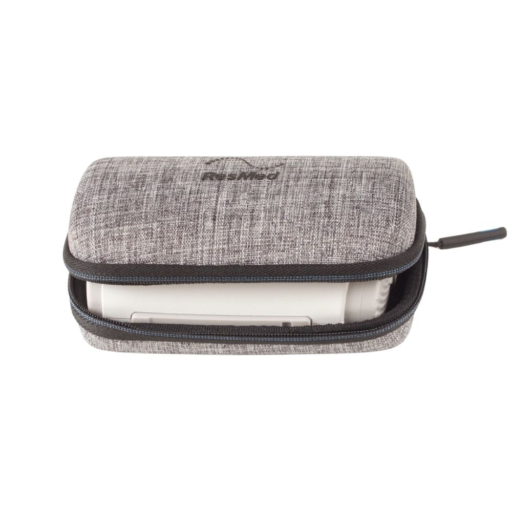 Grey textured ResMed AirMini travel case unzipped with the travel CPAP machine stored inside