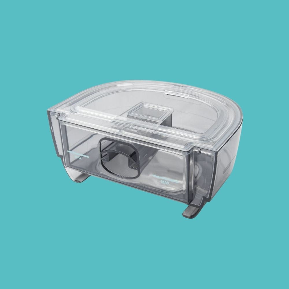 Clear humidifier water container on a teal backrground