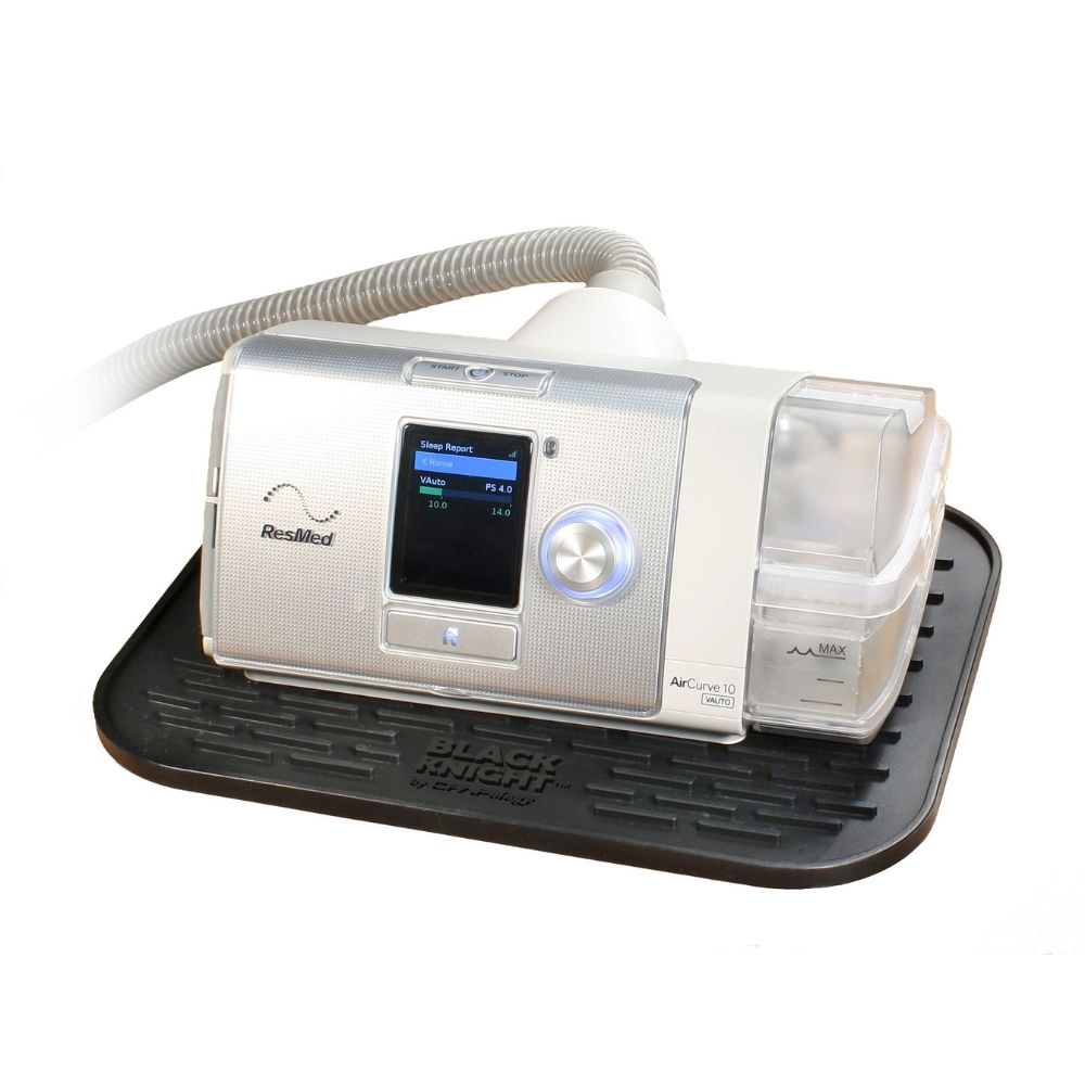 CPAPology Black Knight Non-Slip Protector Mat for CPAP Machines shown with ResMed AirCurve 10 on it