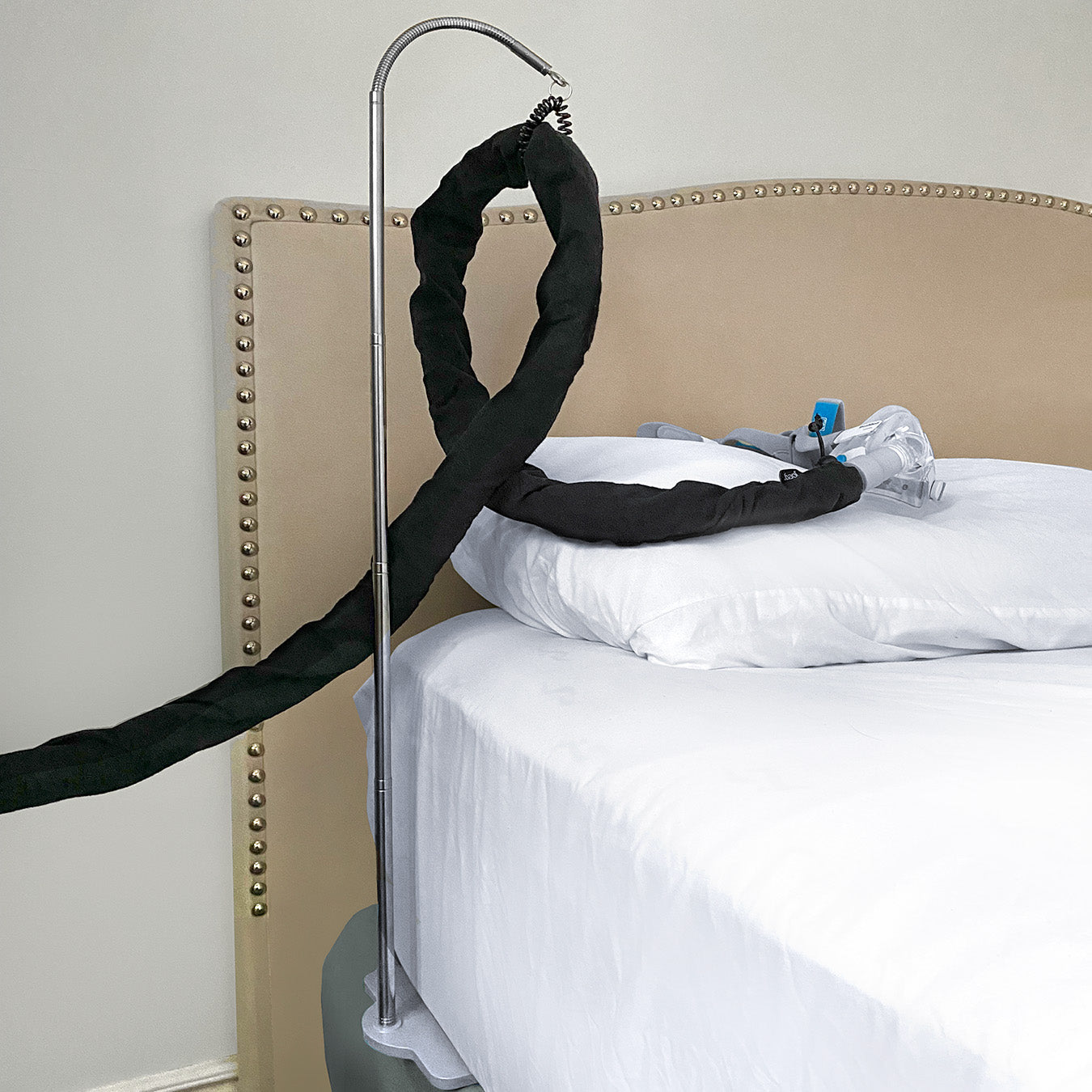 CPAPology Joey CPAP Hose Cover in use and hanging on the Houdini CPAP Hose Support