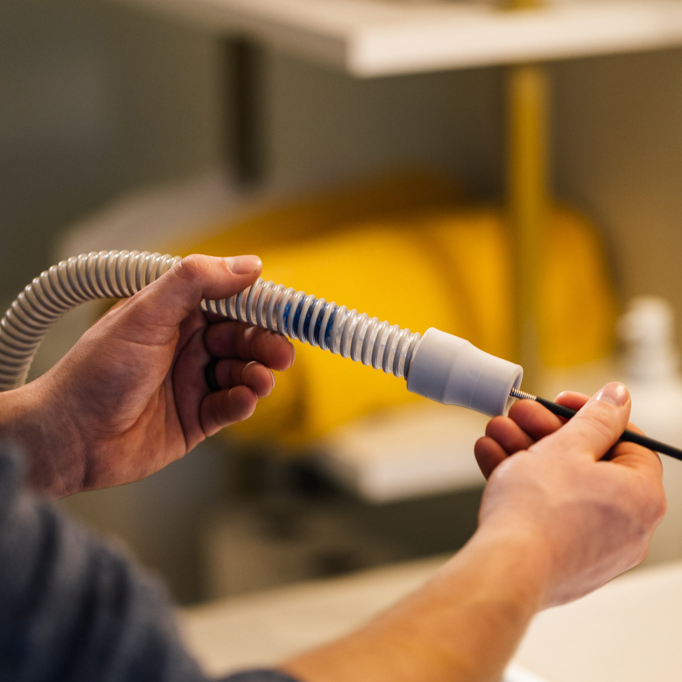 Person using the CPAPology Monty Elite Tube Brush to clean CPAP tube