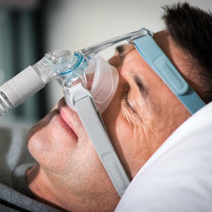 Person sleeping while using the F&P Eson 2 Nasal Mask