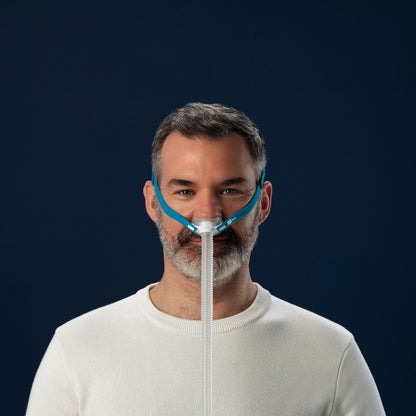 Frontal view of a person wearing the F&P Nova Micro Nasal Pillow Mask