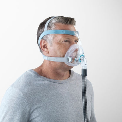 Angled view of a person wearing the F&P Vitera Full Face CPAP Mask with tube
