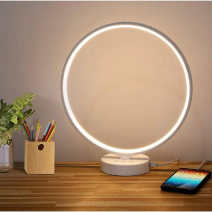Kala SAD Therapy Lamp on a wooden surface with a phone and pencil holder
