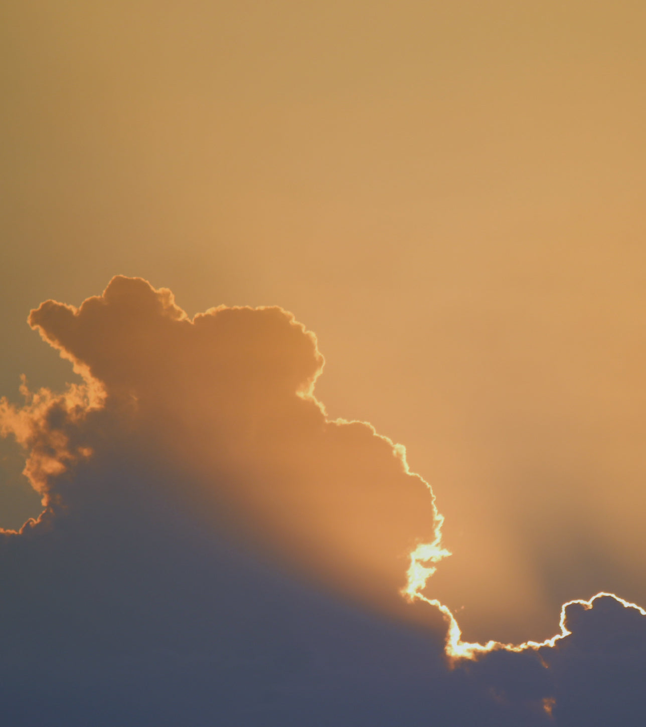 Sunset with orange and blue hues casting a warm glow on the sky