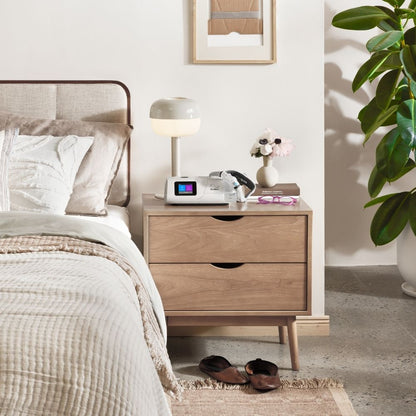 ResMed AirCurve 11 BiPAP machine and CPAP mask on nightstand