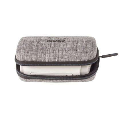 Grey textured ResMed AirMini travel case unzipped with the travel CPAP machine stored inside