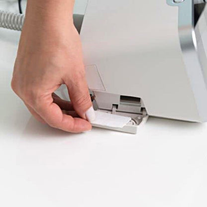 Hand inserting a new white filter onto the side of the Resvent iBreeze machine