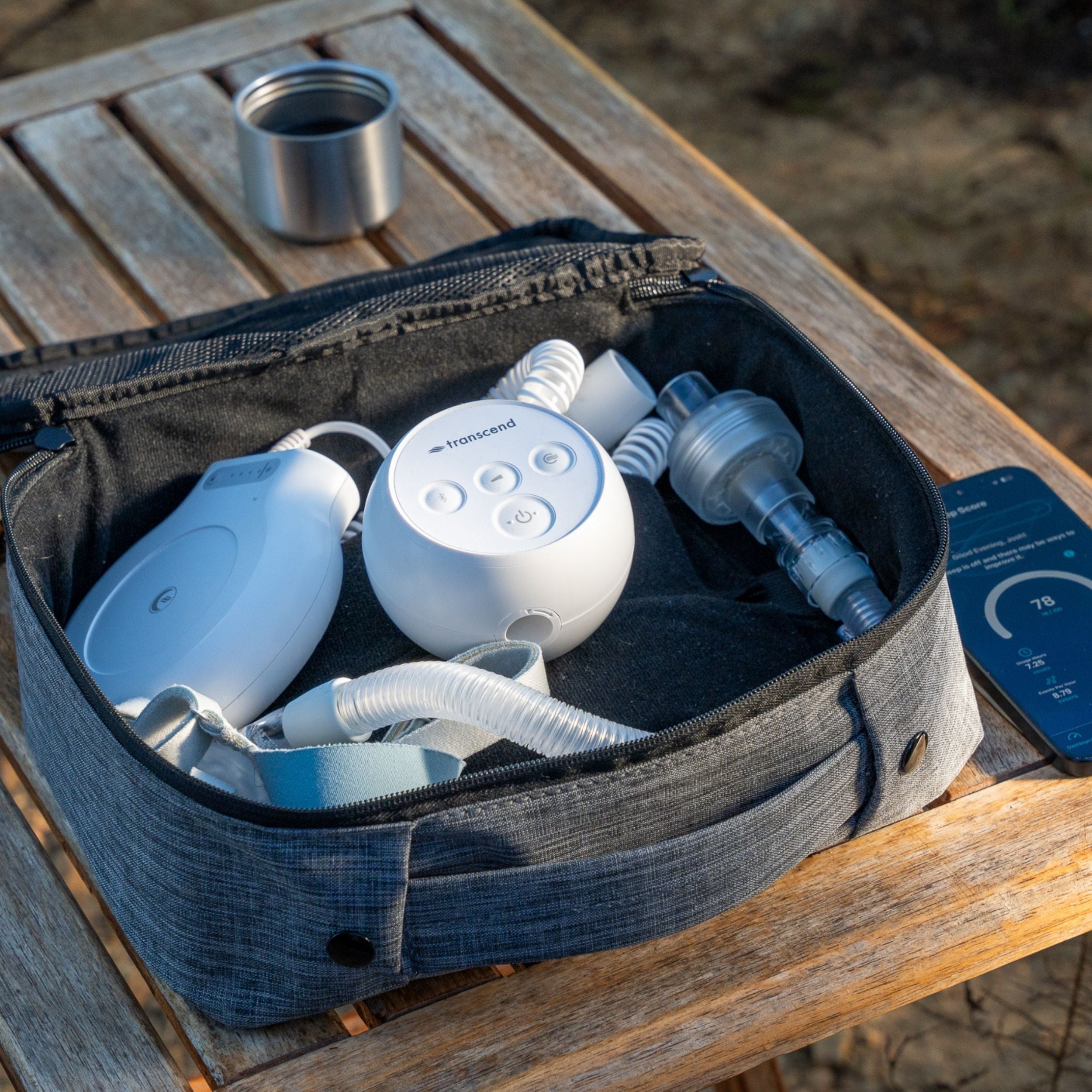 Transcend Micro CPAP device and PowerAway Battery inside travel case on wooden table outside