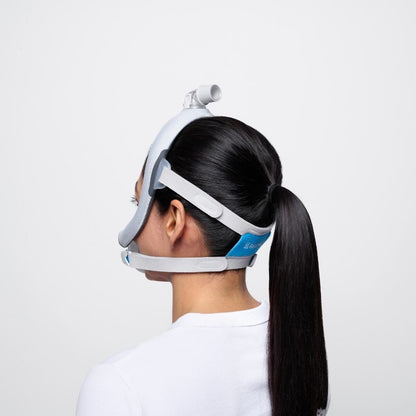 Side profile of a person with a long ponytail wearing the Resmed AirTouch F30i full face mask