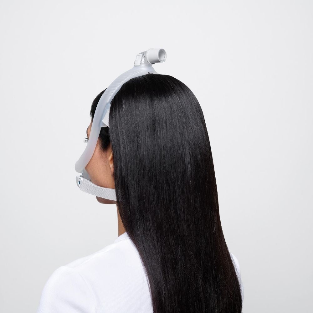 Back view of a person with long black hair wearing the Resmed AirTouch F30i full face mask